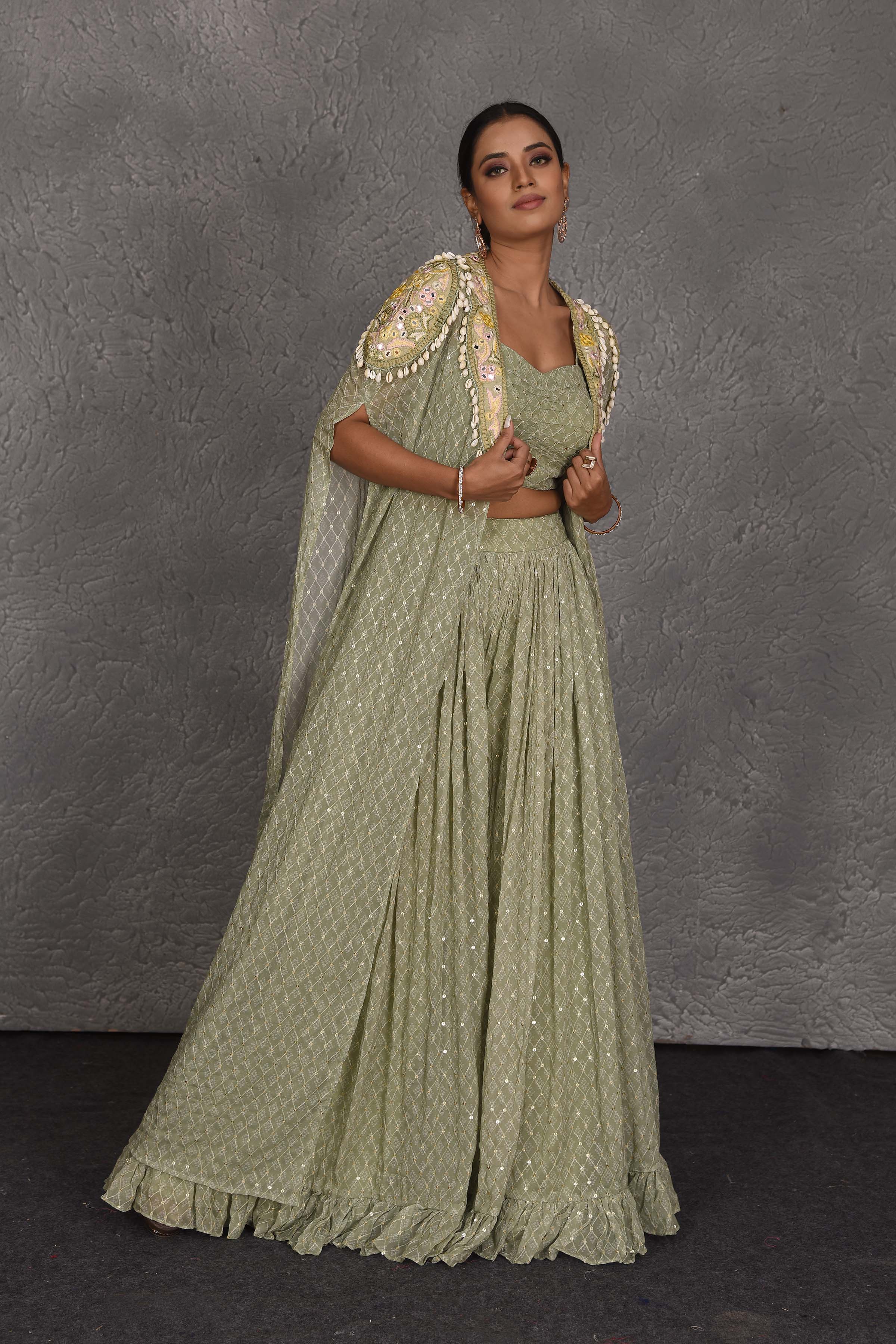 Buy beautiful sage green embroidered sharara pants online in USA with embroidered cape. Flaunt your Indian style on festive occasions in stunning designer lehengas, Anarkali suit, sharara suits, designer gowns, designer sarees, embroidered sarees from Pure Elegance India fashion store in USA. -right