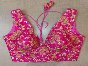 Buy beautiful fuschia pink padded saree blouse online in USA with golden embroidery. Elevate your Indian saree style with exquisite readymade sari blouse, embroidered saree blouses, Banarasi saree blouse, designer sari blouse, choli-cut blouses from Pure Elegance Indian clothing store in USA.-full view