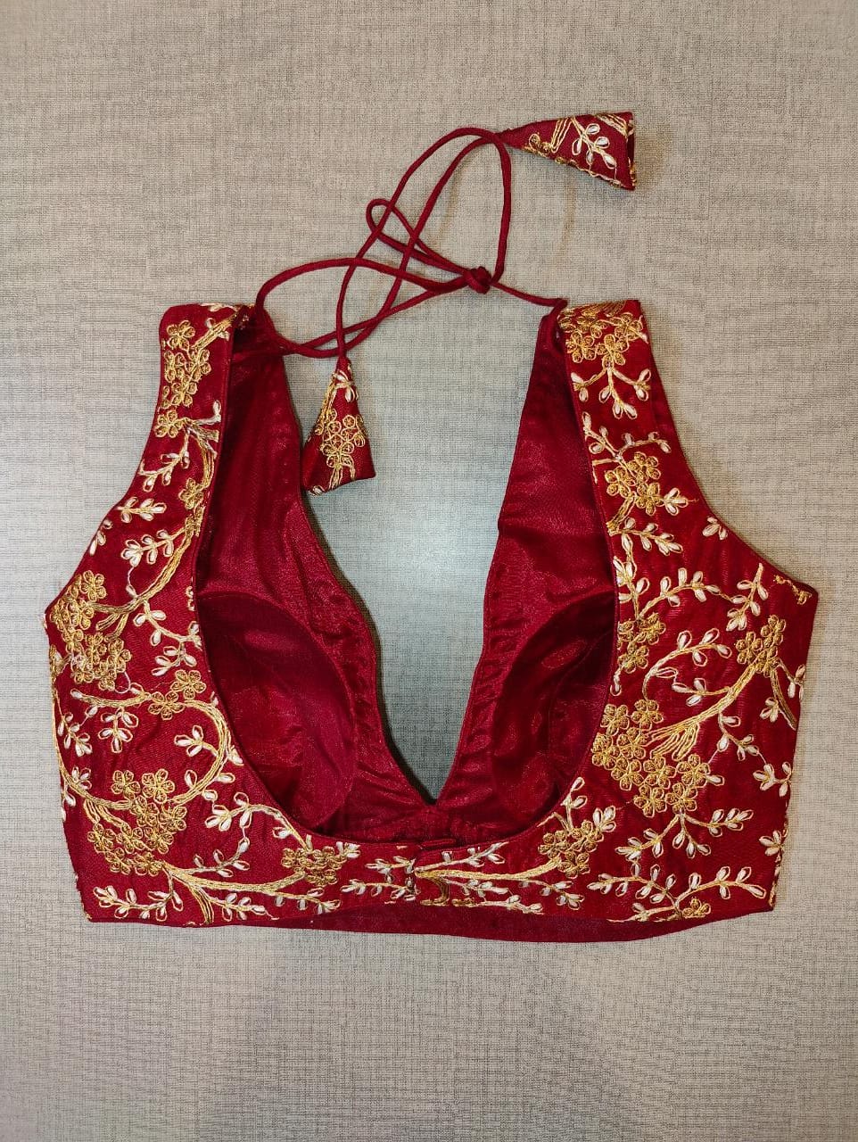 Buy maroon padded saree blouse online in USA with golden embroidery. Elevate your Indian saree style with exquisite readymade sari blouse, embroidered saree blouses, Banarasi saree blouse, designer sari blouse, choli-cut blouses from Pure Elegance Indian clothing store in USA.-back