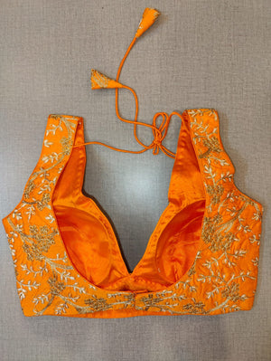Buy beautiful orange sleeveless saree blouse online in USA with golden embroidery. Elevate your Indian saree style with exquisite readymade sari blouse, embroidered saree blouses, Banarasi saree blouse, designer sari blouse, choli-cut blouses from Pure Elegance Indian clothing store in USA.-back