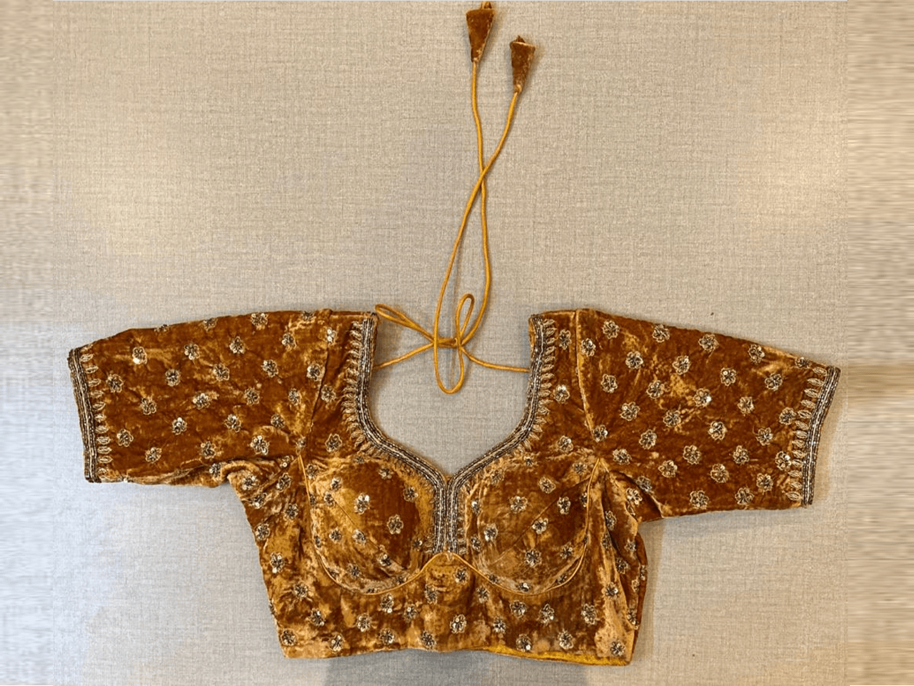 Buy beautiful golden embroidered velvet choli-cut saree blouse online in USA. Elevate your saree style with exquisite readymade saree blouses, embroidered saree blouses, Banarasi saree blouse, designer saree blouse, choli-cut blouses, corset blouses from Pure Elegance Indian clothing store in USA.-full view