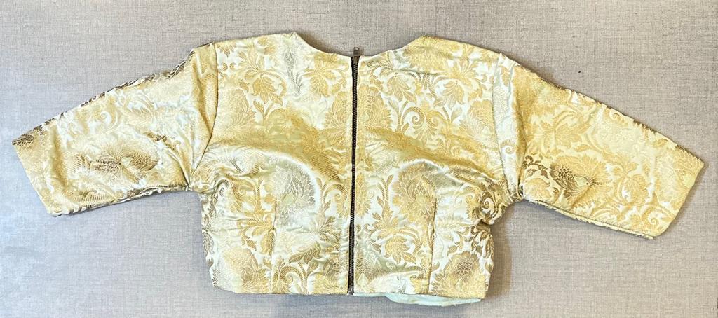 Buy cream golden Banarasi saree blouse online in USA. Elevate your saree style with exquisite readymade saree blouses, embroidered saree blouses, Banarasi saree blouse, designer saree blouse, choli-cut blouses, corset blouses from Pure Elegance Indian clothing store in USA.-back