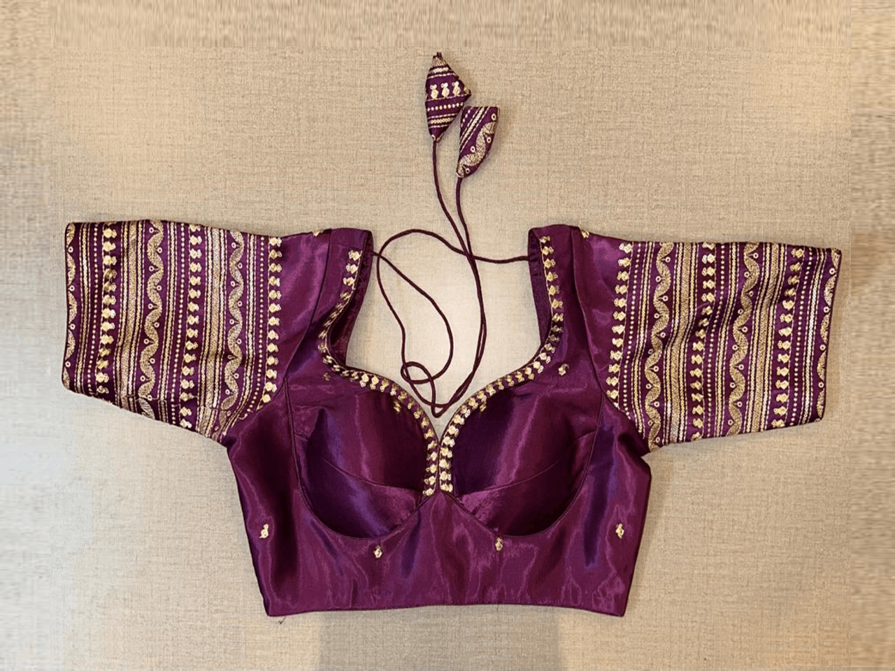 Shop purple choli-cut saree blouse online in USA with golden embroidery. Elevate your saree style with exquisite readymade saree blouses, embroidered saree blouses, Banarasi saree blouse, designer saree blouse, choli-cut blouses, corset blouses from Pure Elegance Indian clothing store in USA.-full view