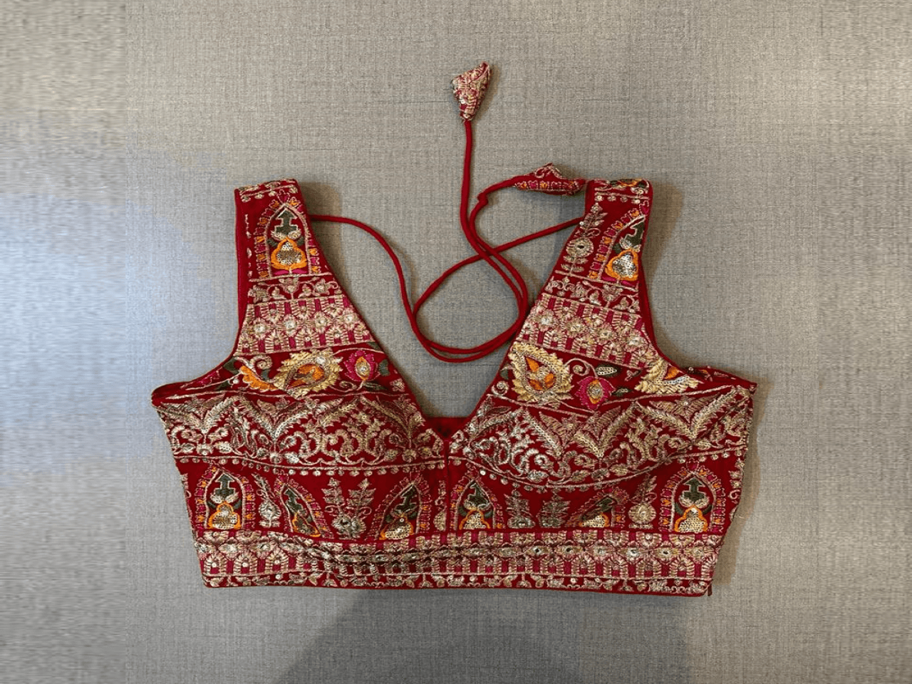Buy beautiful red heavy embroidery sleeveless saree blouse online in USA. Elevate your saree style with exquisite readymade saree blouses, embroidered saree blouses, Banarasi saree blouse, designer saree blouse, choli-cut blouses, corset blouses from Pure Elegance Indian clothing store in USA.-full view