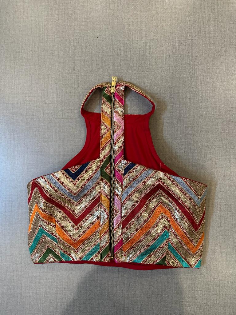 Buy red and golden chevron pattern halter neck sari blouse online in USA. Elevate your saree style with exquisite readymade saree blouses, embroidered saree blouses, Banarasi saree blouse, designer saree blouse, choli-cut blouses, corset blouses from Pure Elegance Indian clothing store in USA.-back