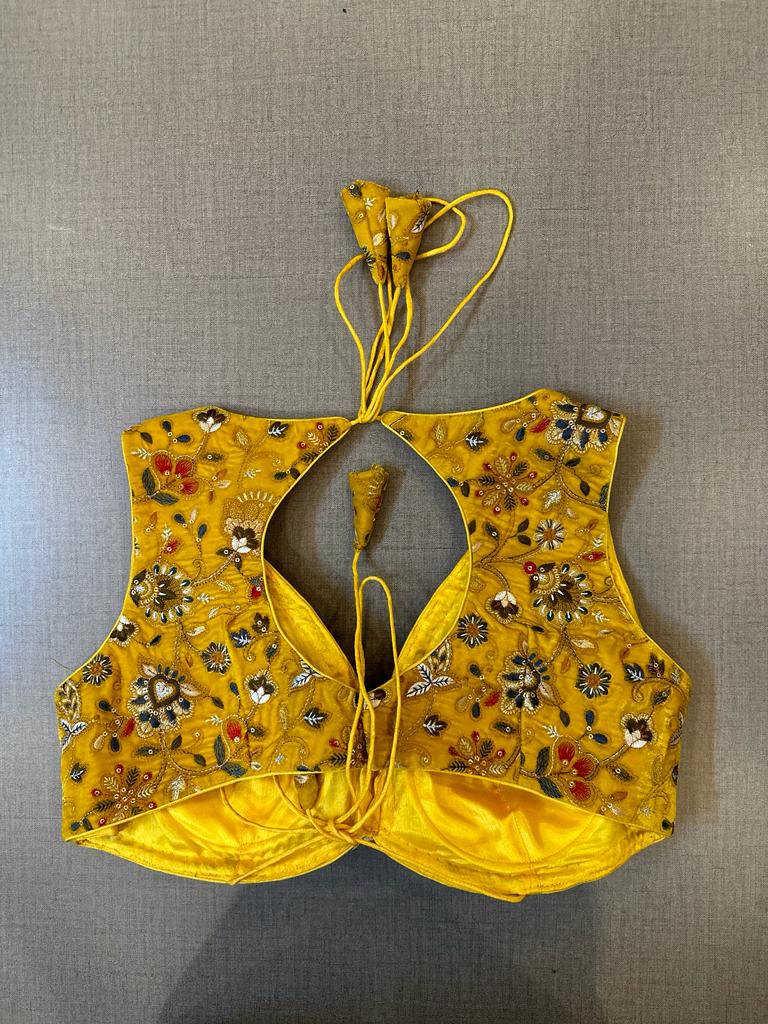 Shop beautiful yellow heavy embroidery velvet saree blouse online in USA. Elevate your saree style with exquisite readymade saree blouses, embroidered saree blouses, Banarasi saree blouse, designer saree blouse, choli-cut blouses, corset blouses from Pure Elegance Indian clothing store in USA.-back