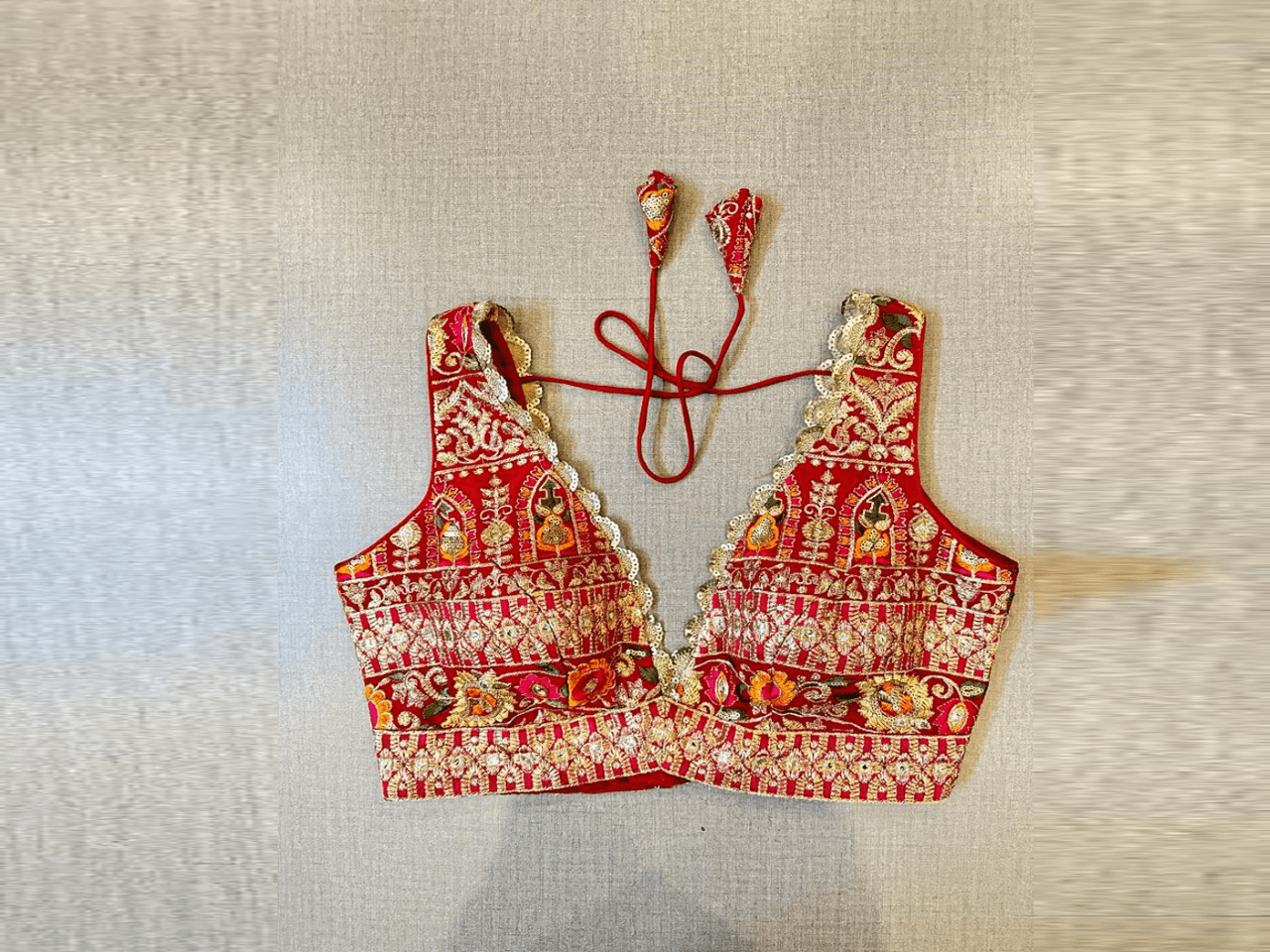 Shop red heavy embroidery sleeveless saree blouse online in USA. Elevate your saree style with exquisite readymade saree blouses, embroidered saree blouses, Banarasi saree blouse, designer saree blouse, choli-cut blouses, corset blouses from Pure Elegance Indian clothing store in USA.-full view