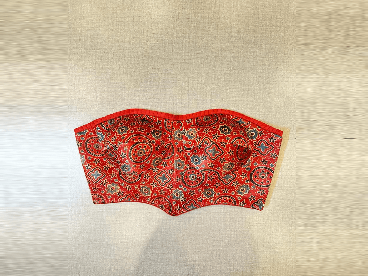 Shop stunning red Ajrak corset blouse online in USA. Elevate your saree style with exquisite readymade saree blouses, embroidered saree blouses, Banarasi saree blouse, designer saree blouse, choli-cut blouses, corset blouses from Pure Elegance Indian clothing store in USA.-full view