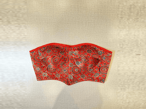 Shop stunning red Ajrak corset blouse online in USA. Elevate your saree style with exquisite readymade saree blouses, embroidered saree blouses, Banarasi saree blouse, designer saree blouse, choli-cut blouses, corset blouses from Pure Elegance Indian clothing store in USA.-full view