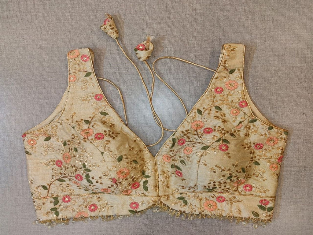 Buy & Give your ethnic look a dazzling update with this off-white blouse. Tailored in silk, it features sleeveless, floral embroidery, a V-neck in the front, and hook closure at the back details. Pair it with a complementary solid sari and diamond stud earrings. Elevate your Indian saree style with exquisite readymade sari blouses, embroidered saree blouses, Banarasi sari blouses, and designer sari blouses from Pure Elegance Indian clothing store in the USA.- Front View