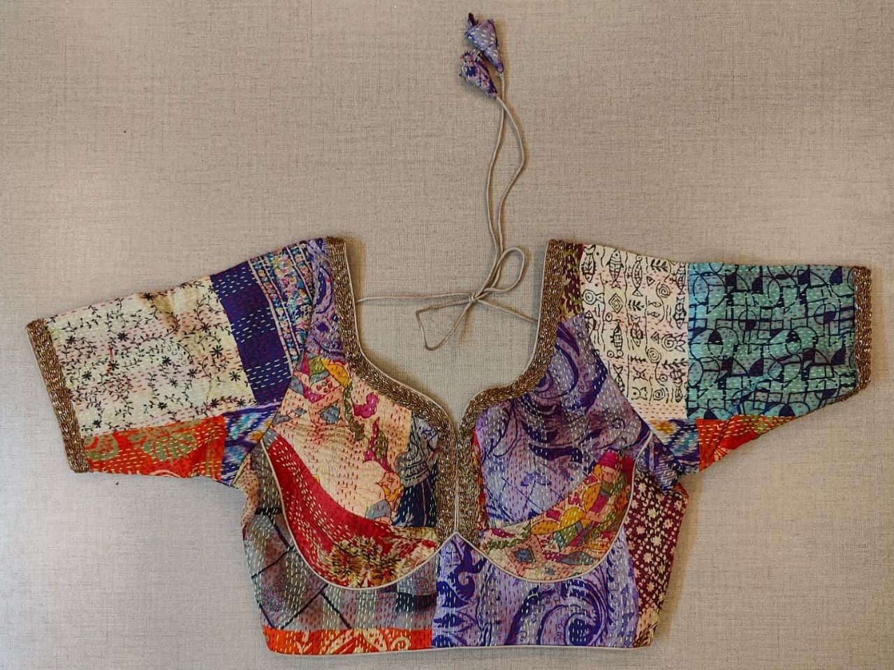 Buy an off-white multicolor printed padded saree blouse, that has a V-neck, short sleeves, tie-up detail at the back, hook, and eye closure. Let your aura shine throughout by wearing this designer saree blouse. Pair this fashionable blouse with a beautiful printed sari and statement neck piece and you are good to go.- Front View