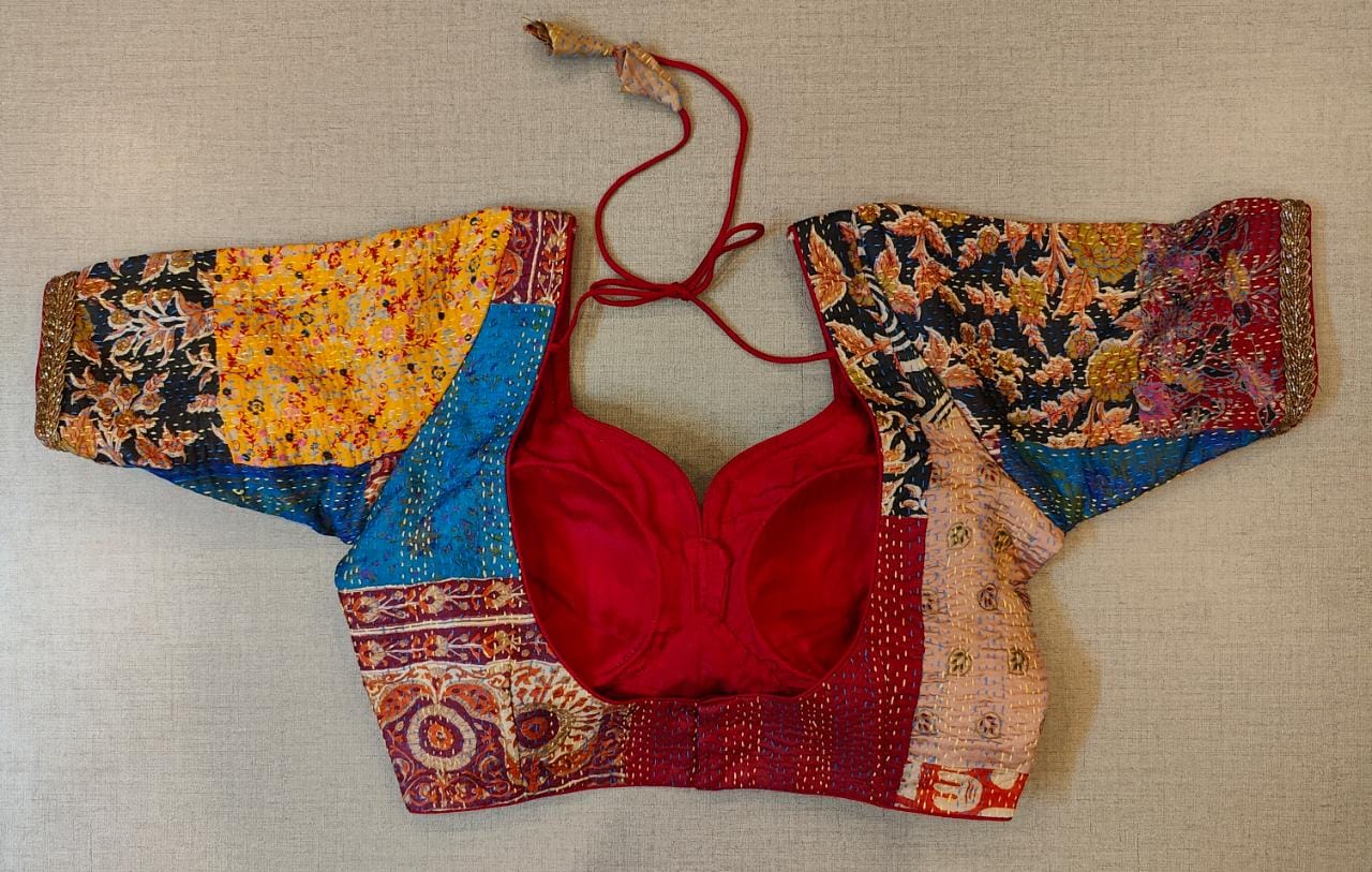Buy a maroon multicolor printed padded saree blouse, that has a V-neck, short sleeves, tie-up detail at the back, hook, and eye closure. Let your aura shine throughout by wearing this designer saree blouse. Pair this fashionable blouse with a beautiful printed sari and statement neck piece and you are good to go. - Back View