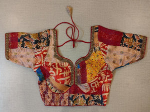Buy a maroon multicolor printed padded saree blouse, that has a V-neck, short sleeves, tie-up detail at the back, hook, and eye closure. Let your aura shine throughout by wearing this designer saree blouse. Pair this fashionable blouse with a beautiful printed sari and statement neck piece and you are good to go. - Front View