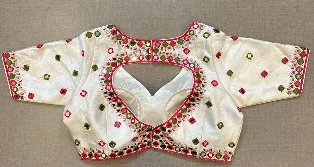 Buy Tailored in a timeless hue and topped with multicolor thread and mirror work details, this blouse is an evergreen addition to your festive wardrobe and party look. It is designed with a V neckline, 3/4th sleeves, and back hook closure. Buy this designer blouse in the USA from Pure Elegance. 