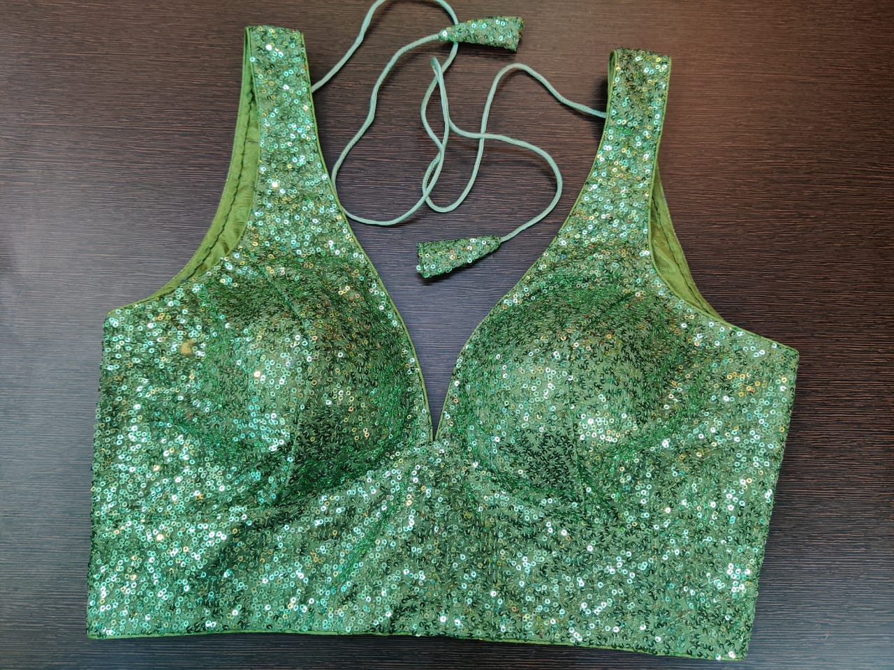 Buy stunning green sequin work sleeveless saree blouse online in USA. Elevate your Indian saree style with exquisite readymade sari blouse, embroidered saree blouses, Banarasi sari blouse, designer sari blouse from Pure Elegance Indian clothing store in USA.-front