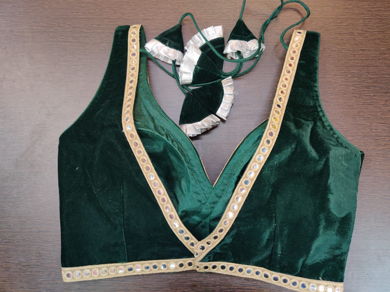 Shop beautiful dark green velvet sleeveless saree blouse online in USA with mirror lace. Elevate your Indian saree style with exquisite readymade sari blouse, embroidered saree blouses, Banarasi sari blouse, designer saree blouse from Pure Elegance Indian clothing store in USA.-back