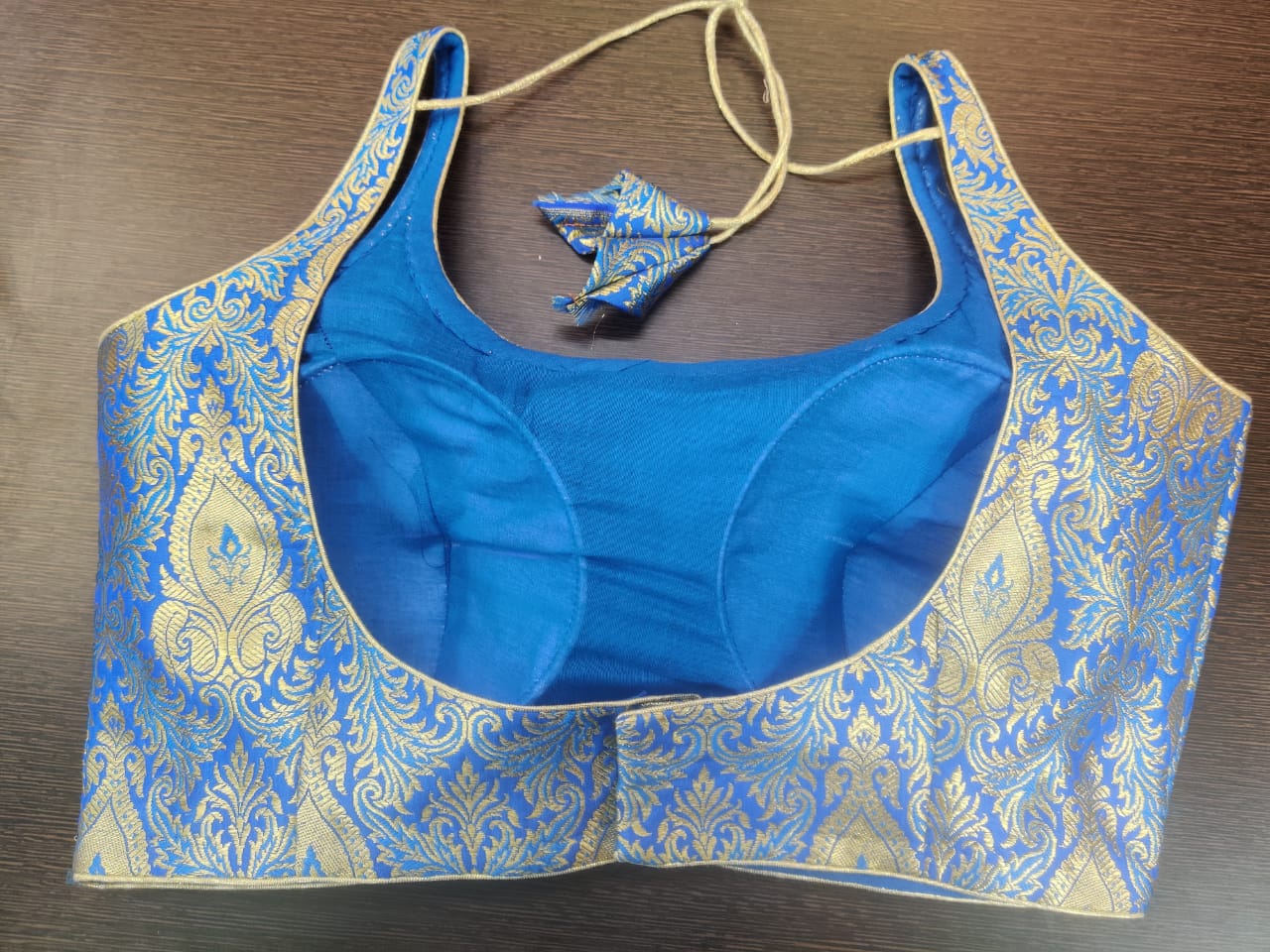 Buy blue sleeveless readymade Banarasi saree blouse online in USA. Elevate your Indian saree style with exquisite readymade sari blouse, embroidered saree blouses, Banarasi sari blouse, designer saree blouse from Pure Elegance Indian clothing store in USA.-back