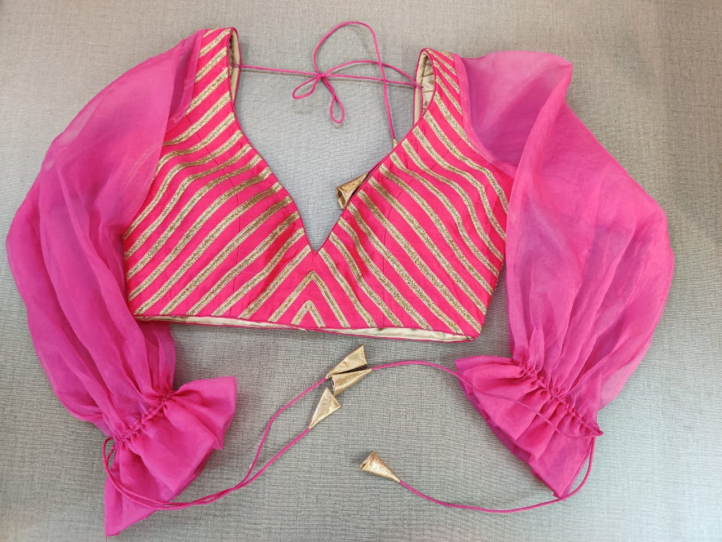 Shop beautiful pink and golden designer saree blouse online in USA with balloon sleeves. Elevate your Indian ethnic sari looks with exquisite readymade saree blouse, embroidered saree blouses, Banarasi sari blouse, designer sari blouse from Pure Elegance Indian clothing store in USA.-front