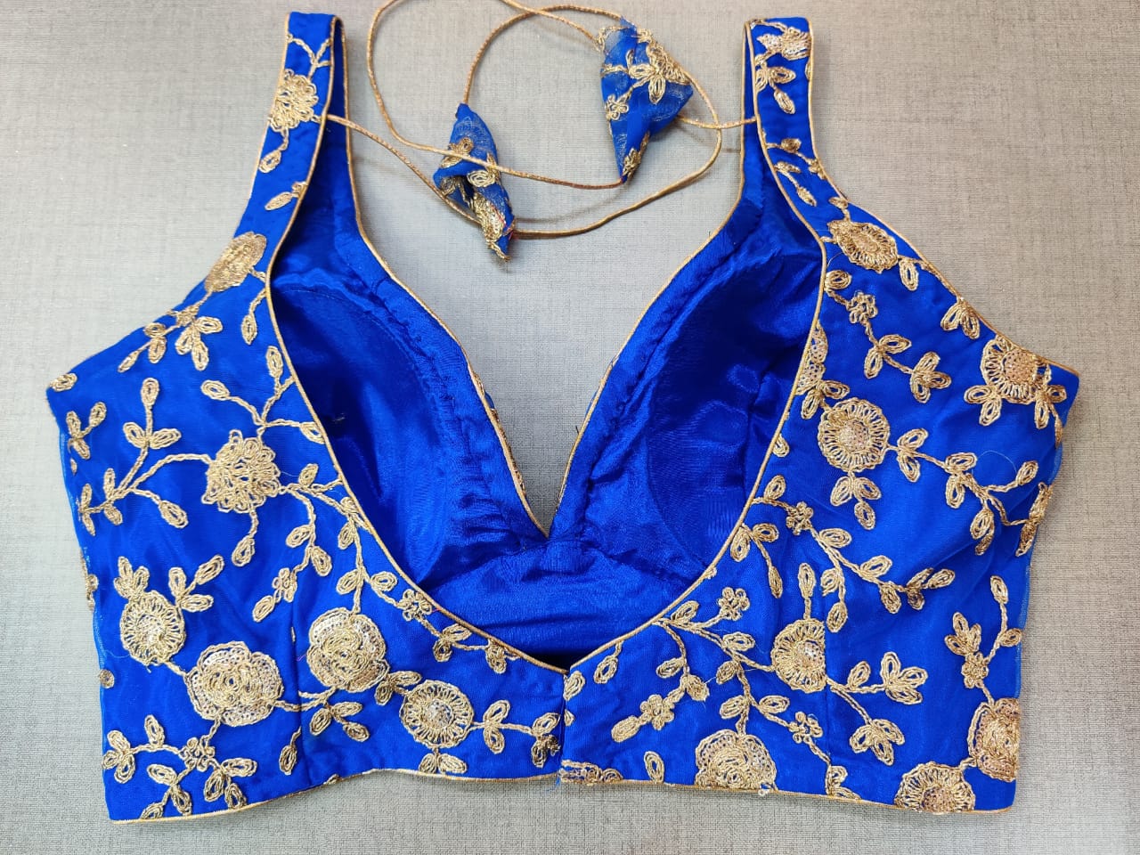 Shop beautiful ink blue sleeveless sari blouse online in USA with golden embroidery. Elevate your Indian ethnic sari looks with exquisite readymade saree blouse, embroidered saree blouses, Banarasi sari blouse, designer saree blouse from Pure Elegance Indian clothing store in USA.-back