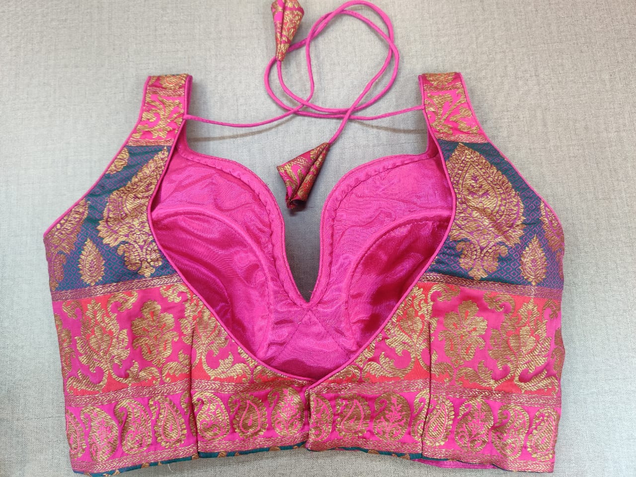 Shop stunning pink Banarasi sleeveless saree blouse online in USA. Elevate your Indian ethnic sari looks with exquisite readymade saree blouse, embroidered saree blouses, Banarasi sari blouse, designer saree blouse from Pure Elegance Indian clothing store in USA.-back
