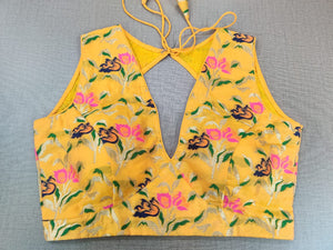 Shop stunning yellow Banarasi sleeveless saree blouse online in USA. Elevate your Indian ethnic sari looks with exquisite readymade saree blouse, embroidered saree blouses, Banarasi sari blouse, designer saree blouse from Pure Elegance Indian clothing store in USA.-front