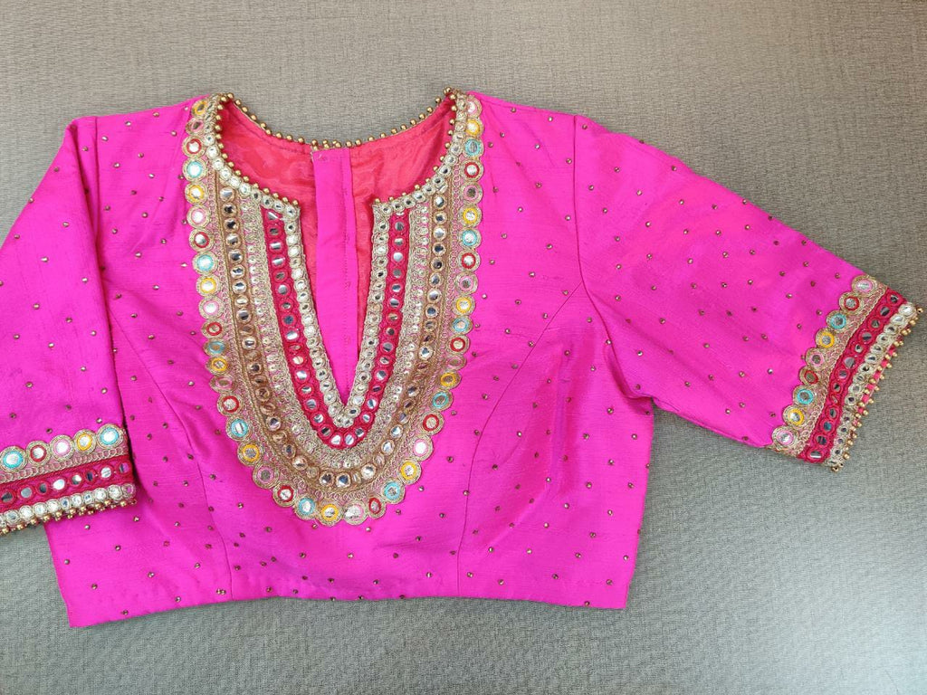 Shop beautiful neon pink embroidered saree blouse online in USA with mirror work. Elevate your Indian ethnic sari looks with exquisite readymade saree blouse, embroidered saree blouses, Banarasi saree blouse, designer saree blouse from Pure Elegance Indian clothing store in USA.-front