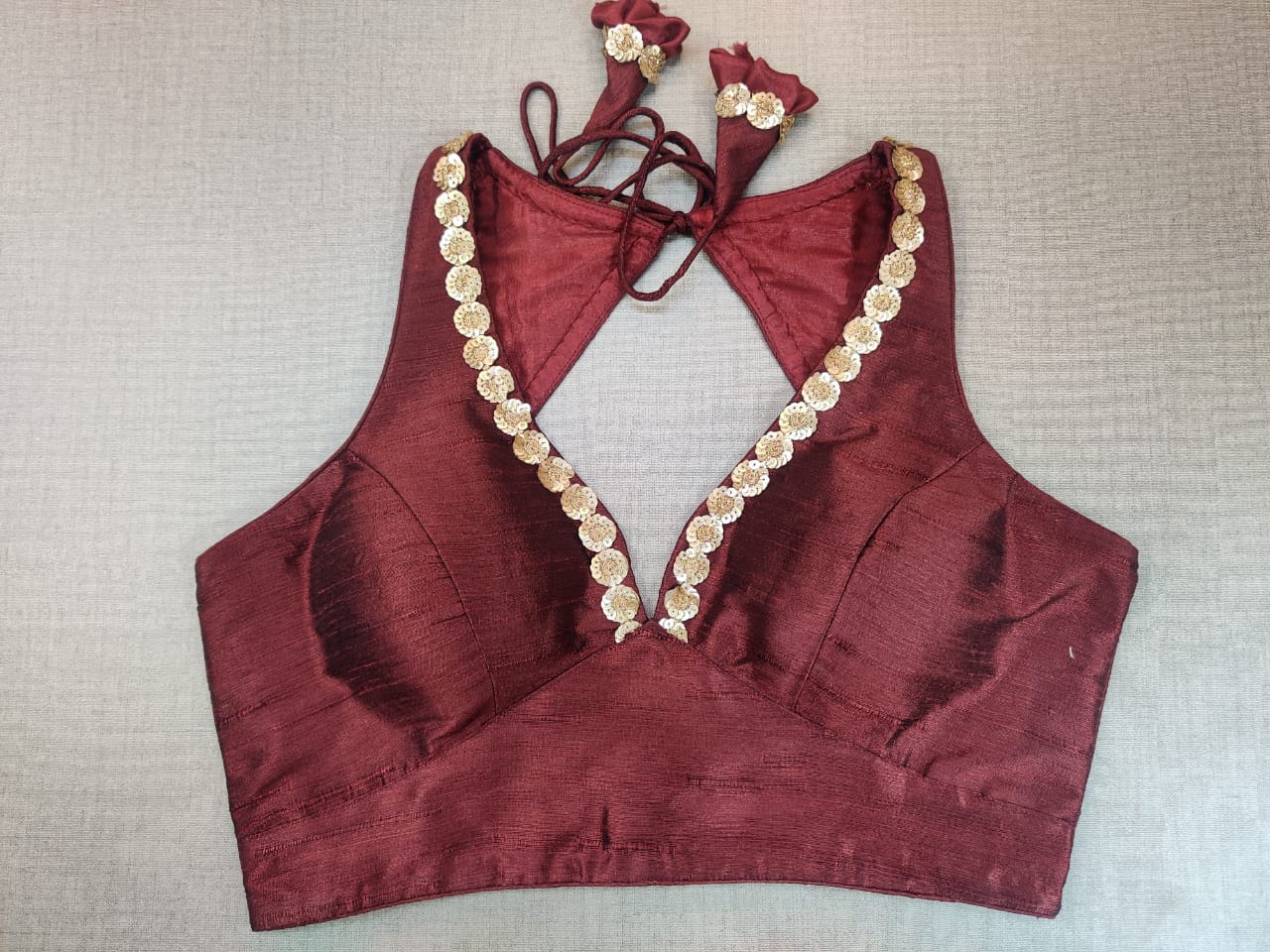 Buy stunning maroon sleeveless sari blouse online in USA with sequin work neckline. Elevate your Indian ethnic saree looks with beautiful readymade sari blouse, embroidered saree blouses, Banarasi saree blouse, designer saree blouse from Pure Elegance Indian clothing store in USA.-full view