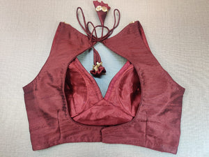 Buy stunning maroon sleeveless sari blouse online in USA with sequin work neckline. Elevate your Indian ethnic saree looks with beautiful readymade sari blouse, embroidered saree blouses, Banarasi saree blouse, designer saree blouse from Pure Elegance Indian clothing store in USA.-back
