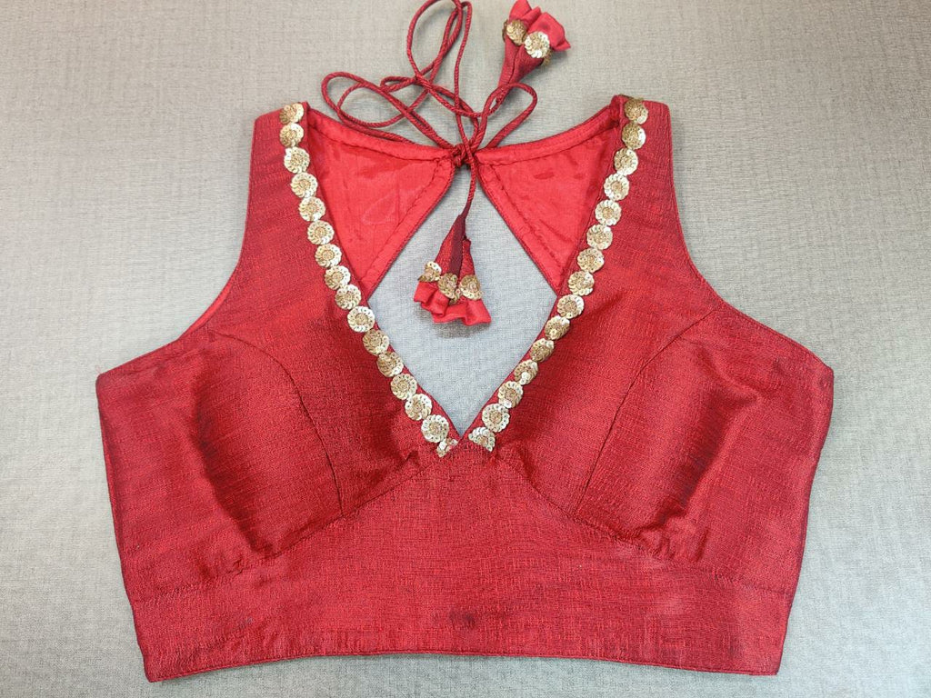 Buy beautiful red sleeveless sari blouse online in USA with sequin work neckline. Elevate your Indian ethnic saree looks with beautiful readymade sari blouse, embroidered saree blouses, Banarasi saree blouse, designer saree blouse from Pure Elegance Indian clothing store in USA.-front