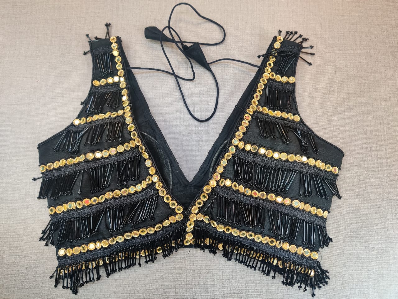 Shop beautiful black and golden mirror work tassel saree blouse online in USA. Elevate your Indian ethnic saree looks with beautiful readymade sari blouse, embroidered saree blouses, Banarasi saree blouse, designer saree blouse from Pure Elegance Indian clothing store in USA.-back