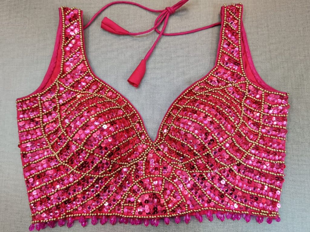 Shop beautiful pink bead work sleeveless saree blouse online in USA. Elevate your Indian ethnic saree looks with beautiful readymade sari blouse, embroidered saree blouses, Banarasi saree blouse, designer saree blouse from Pure Elegance Indian clothing store in USA.-front