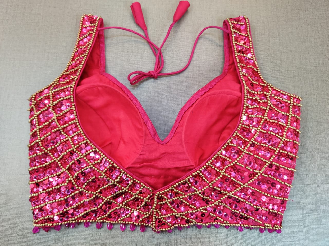 Shop beautiful pink bead work sleeveless saree blouse online in USA. Elevate your Indian ethnic saree looks with beautiful readymade sari blouse, embroidered saree blouses, Banarasi saree blouse, designer saree blouse from Pure Elegance Indian clothing store in USA.-back