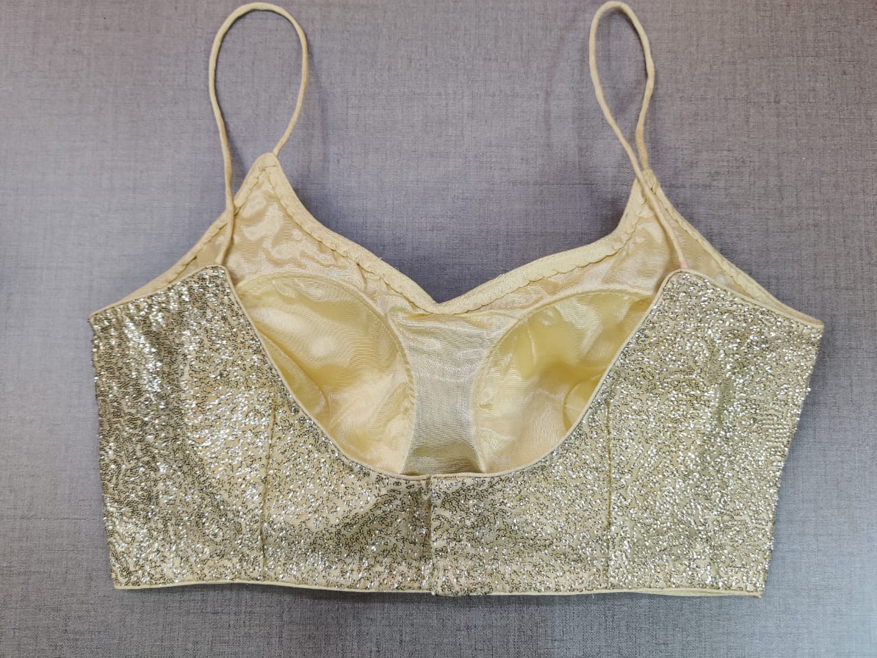 Shop stunning golden shimmer strappy saree blouse online in USA. Elevate your Indian ethnic saree looks with beautiful readymade saree blouse, embroidered sari blouses, Banarasi sari blouse, designer saree blouse from Pure Elegance Indian fashion store in USA.-back