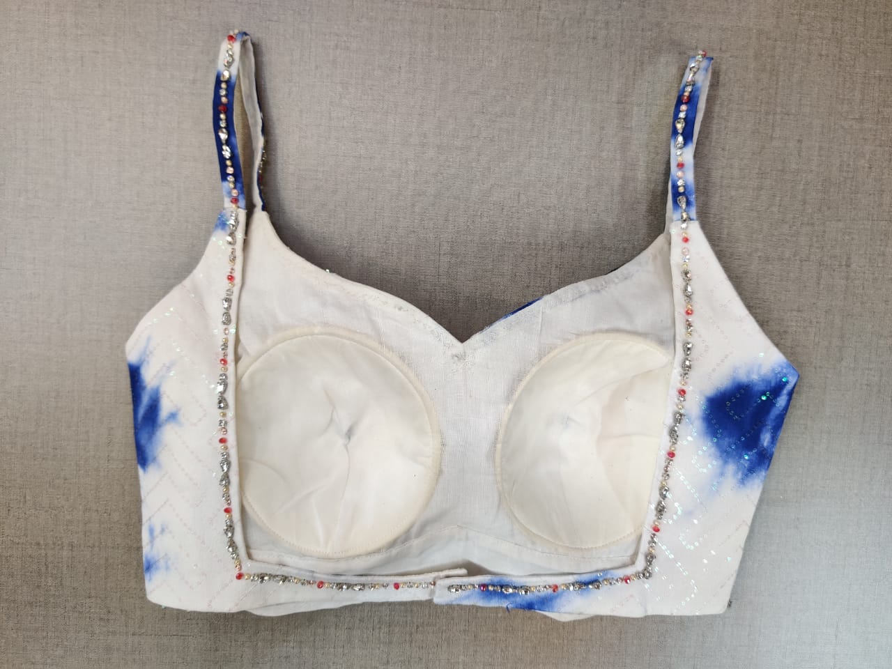 Buy gorgeous white and blue embellished tie and dye saree blouse online in USA. Elevate your Indian ethnic saree looks with beautiful readymade saree blouse, embroidered saree blouses, Banarasi saree blouse, designer sari blouses from Pure Elegance Indian fashion store in USA.-back