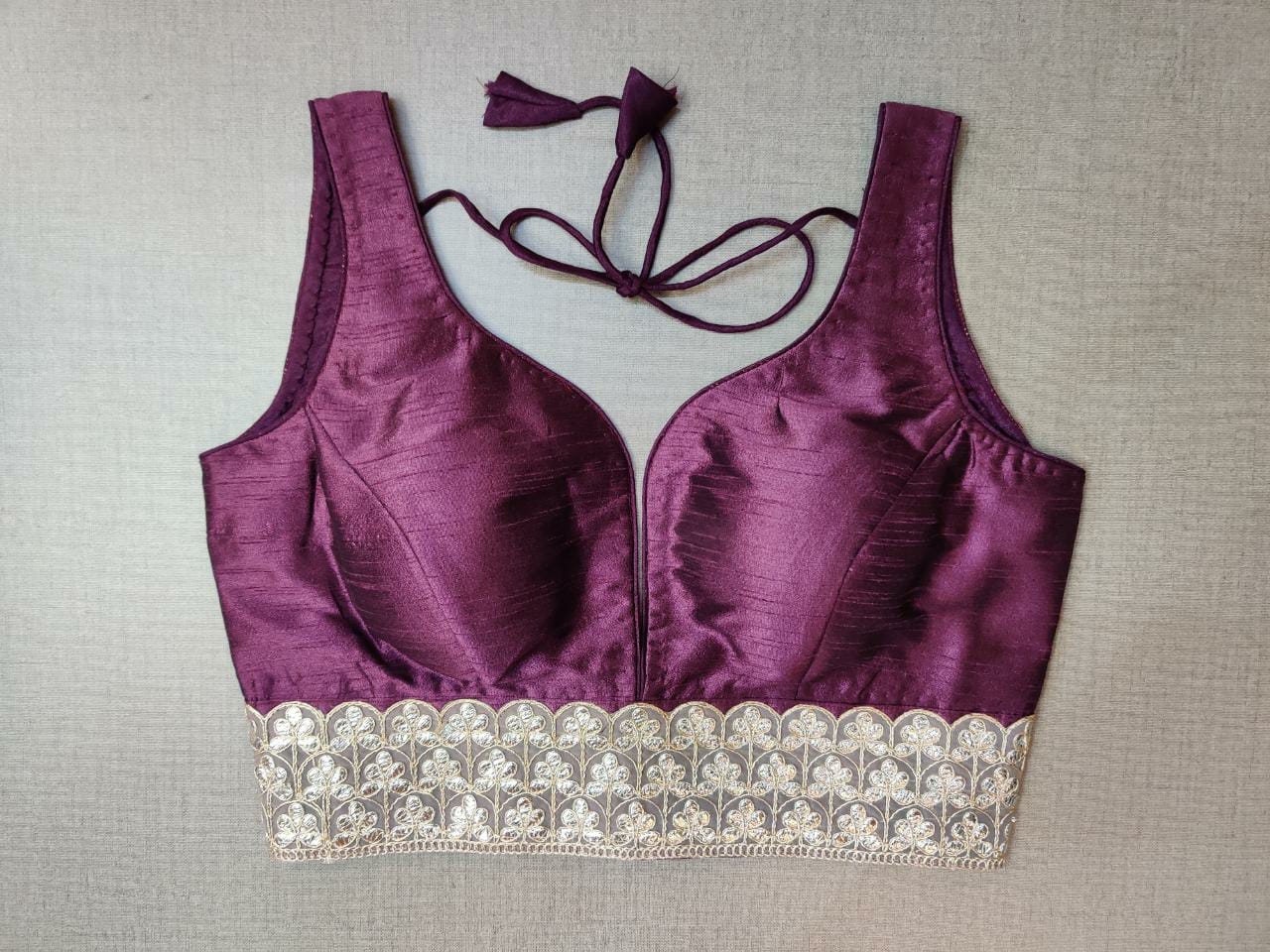 Buy gorgeous plum shade sleeveless saree blouse online in USA with lace border. Elevate your Indian ethnic saree looks with beautiful readymade saree blouse, embroidered saree blouses, Banarasi saree blouse, designer saree blouses from Pure Elegance Indian fashion store in USA.-front