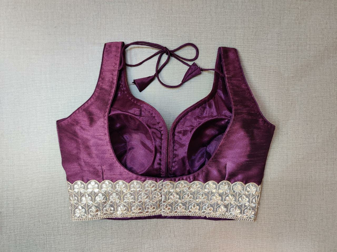 Buy gorgeous plum shade sleeveless saree blouse online in USA with lace border. Elevate your Indian ethnic saree looks with beautiful readymade saree blouse, embroidered saree blouses, Banarasi saree blouse, designer saree blouses from Pure Elegance Indian fashion store in USA.-back