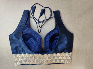 Shop stunning dark blue sleeveless saree blouse online in USA with lace border. Elevate your Indian ethnic saree looks with beautiful readymade saree blouse, embroidered saree blouses, Banarasi saree blouse, designer saree blouses from Pure Elegance Indian fashion store in USA.-back