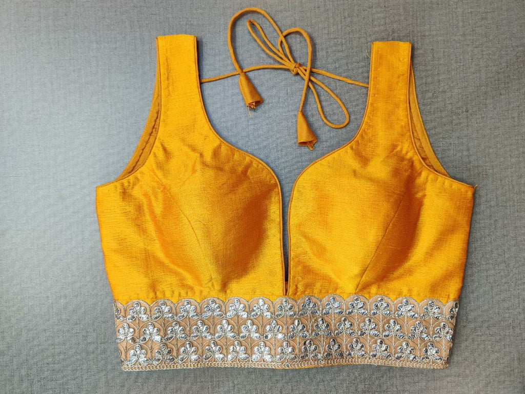 Buy beautiful yellow sleeveless saree blouse online in USA with lace border. Elevate your Indian ethnic saree looks with beautiful readymade saree blouse, embroidered saree blouses, Banarasi saree blouse, designer saree blouses from Pure Elegance Indian fashion store in USA.-front