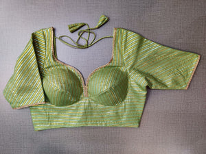 Buy stunning green and golden readymade saree blouse online in USA. Elevate your Indian ethnic saree looks with beautiful readymade saree blouse, embroidered saree blouses, Banarasi saree blouse, designer saree blouses from Pure Elegance Indian fashion store in USA.-front