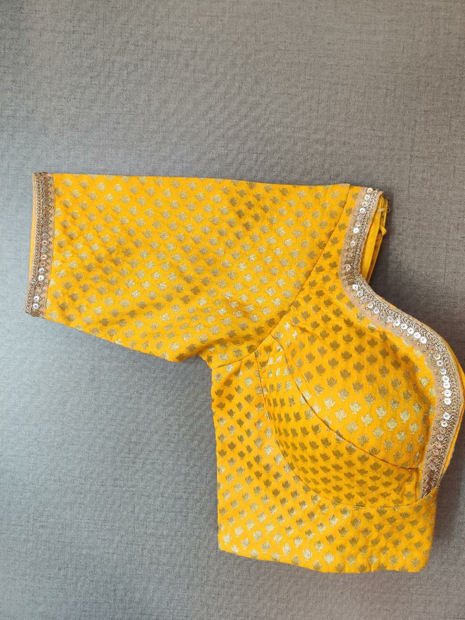 Shop gorgeous mango yellow Banarasi saree blouse online in USA with silver lace. Elevate your Indian ethnic saree looks with beautiful readymade sari blouse, embroidered saree blouses, Banarasi saree blouse, designer sari blouses, sleeveless saree blouses from Pure Elegance Indian fashion store in USA.-sleeves