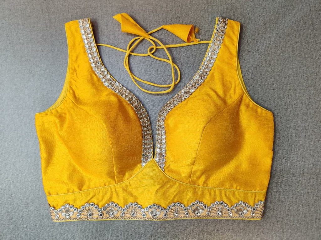 Shop stunning yellow sleeveless sari blouse online in USA with silver embroidery lace. Elevate your Indian ethnic saree looks with beautiful readymade sari blouse, embroidered saree blouses, Banarasi saree blouse, designer sari blouses, sleeveless saree blouses from Pure Elegance Indian fashion store in USA.-front