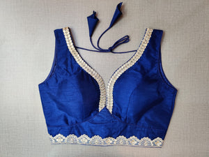 Buy beautiful dark blue sleeveless saree blouse online in USA with silver embroidery lace. Elevate your Indian ethnic saree looks with beautiful readymade sari blouse, embroidered saree blouses, Banarasi saree blouse, designer sari blouses, sleeveless saree blouses from Pure Elegance Indian fashion store in USA.-front