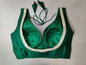 Buy beautiful bottle green sleeveless saree blouse online in USA with silver embroidery lace. Elevate your Indian ethnic saree looks with beautiful readymade sari blouse, embroidered saree blouses, Banarasi saree blouse, designer sari blouses, sleeveless saree blouses from Pure Elegance Indian fashion store in USA.-back