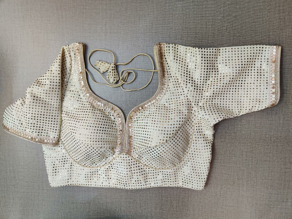 Buy stunning cream designer saree blouse online in USA with stone work. Elevate your Indian ethnic saree looks with beautiful readymade sari blouse, embroidered saree blouses, Banarasi saree blouse, designer saree blouses, sleeveless saree blouses from Pure Elegance Indian fashion store in USA.-front