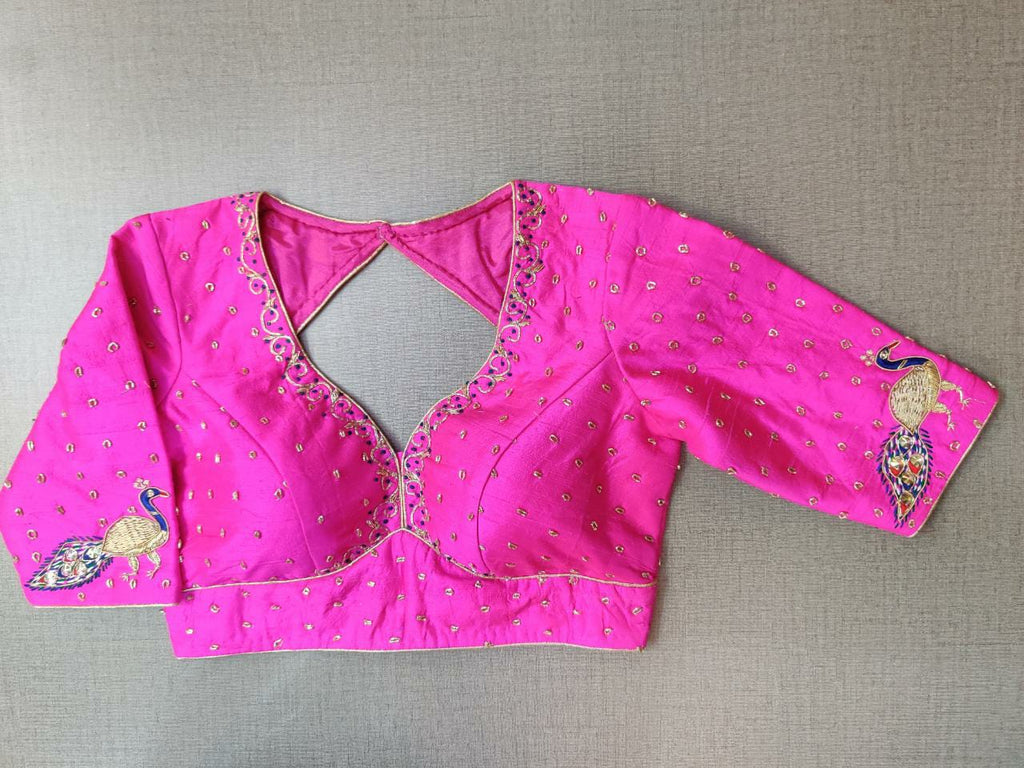 Shop stunning neon pink embroidered saree blouse online in USA with peacock motifs. Elevate your Indian ethnic saree looks with beautiful readymade sari blouse, embroidered saree blouses, Banarasi saree blouse, designer saree blouses, sleeveless saree blouses from Pure Elegance Indian fashion store in USA.-front