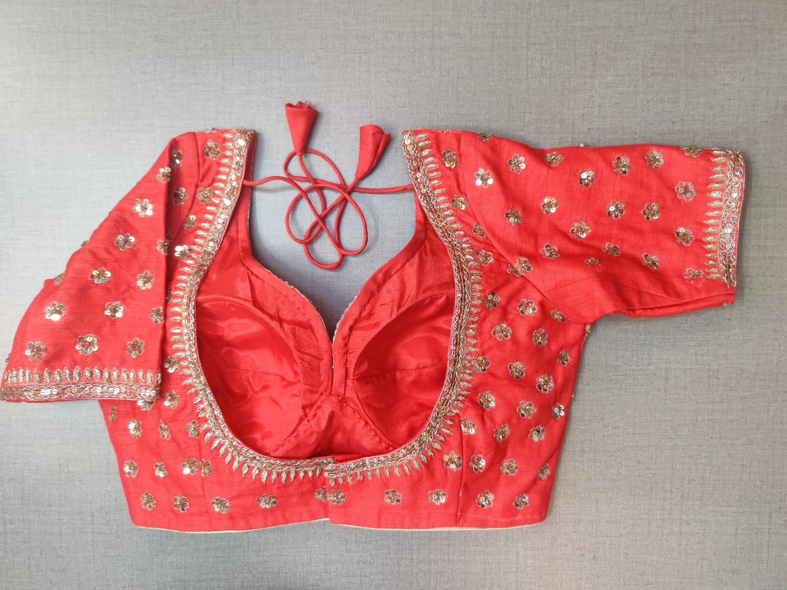 Buy beautiful tomato red embroidered designer saree blouse online in USA. Elevate your Indian ethnic saree looks with beautiful readymade sari blouse, embroidered saree blouses, Banarasi saree blouse, designer saree blouses, sleeveless saree blouses from Pure Elegance Indian fashion store in USA.-back