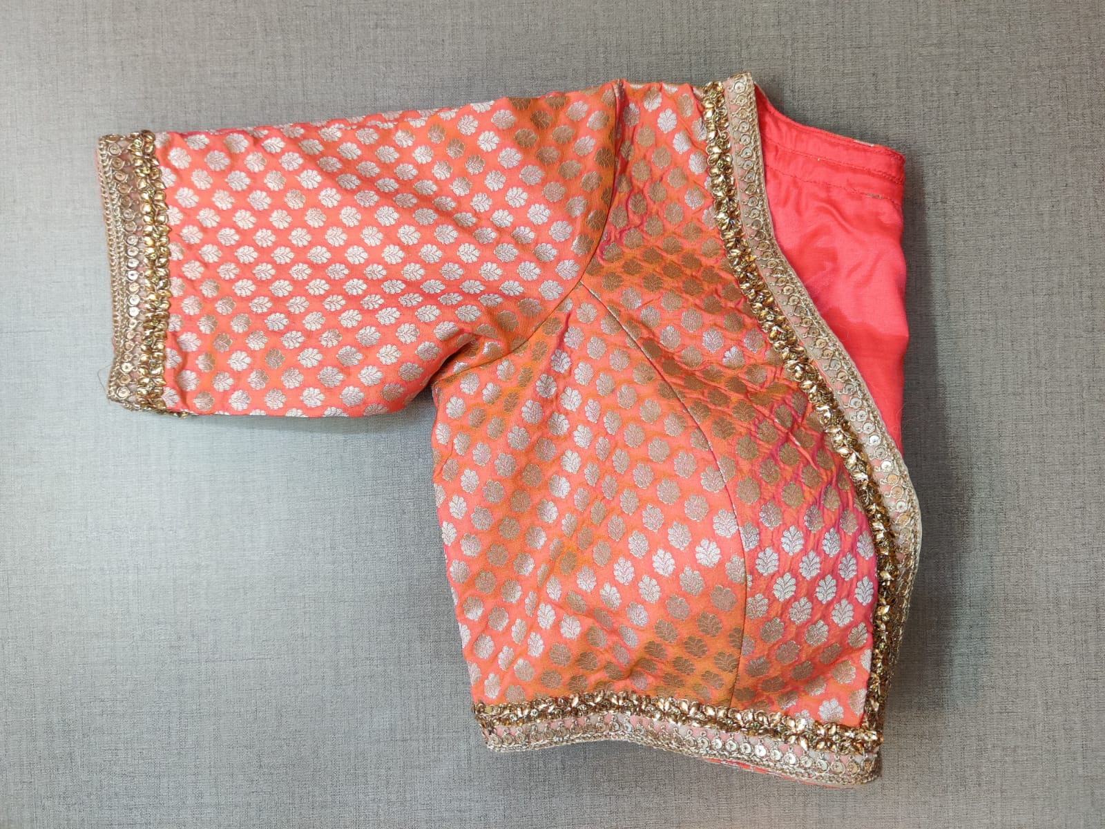 Shop stunning peach embroidered Banarasi saree blouse online in USA. Elevate your Indian ethnic saree looks with beautiful readymade sari blouse, embroidered saree blouses, Banarasi saree blouse, designer saree blouses, sleeveless saree blouses from Pure Elegance Indian fashion store in USA.-sleeves