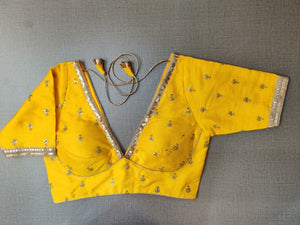 Buy yellow designer saree blouse online in USA with embroidery. Elevate your Indian ethnic saree looks with beautiful readymade sari blouse, embroidered saree blouses, Banarasi saree blouse, designer saree blouses, sleeveless saree blouses from Pure Elegance Indian fashion store in USA.-front