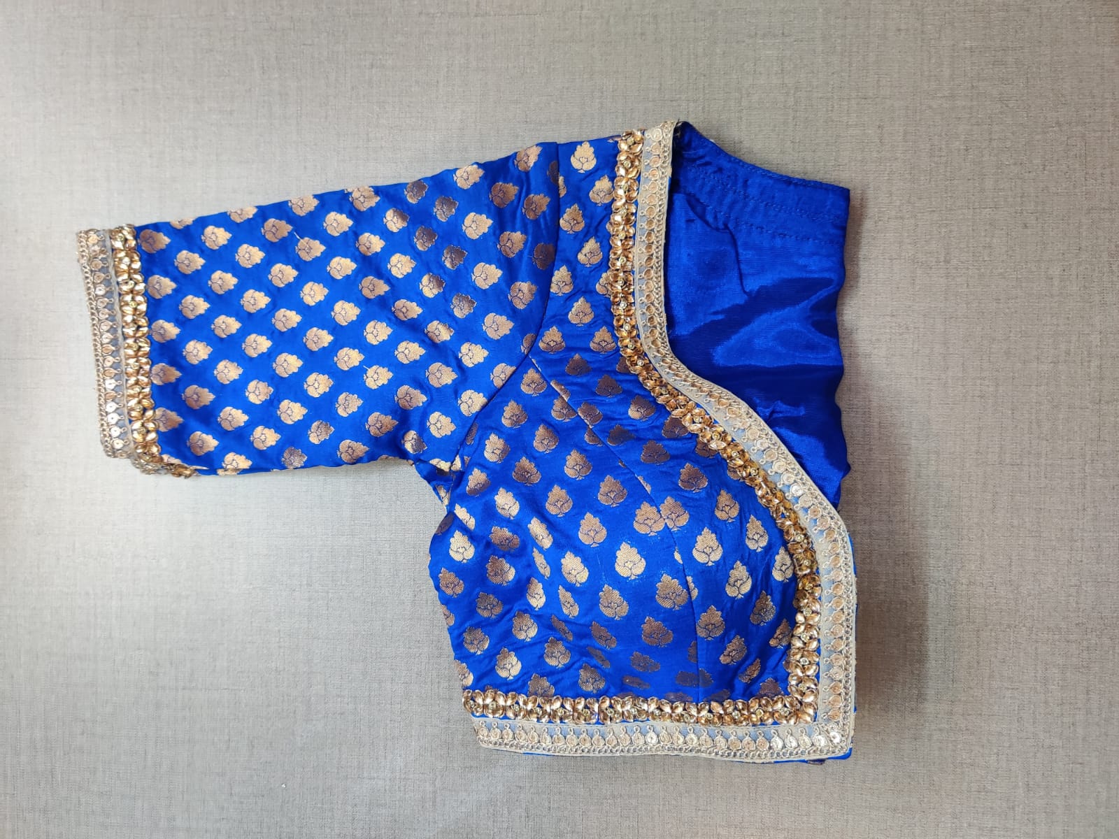 Buy stunning blue Banarasi saree blouse online in USA with embroidery. Elevate your Indian ethnic saree looks with beautiful readymade sari blouse, embroidered saree blouses, Banarasi saree blouse, designer saree blouses, sleeveless saree blouses from Pure Elegance Indian fashion store in USA.-sleeves
