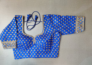 Buy beautiful blue designer saree blouse online in USA with golden embroidery. Elevate your Indian ethnic saree looks with beautiful readymade sari blouse, embroidered saree blouses, Banarasi saree blouse, designer saree blouses, sleeveless saree blouses from Pure Elegance Indian fashion store in USA.-front